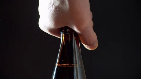 Man's hand opening a bottle of beer Stock Footage 124292731