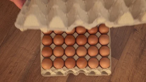 Man’s hand opening an egg package Stock Footage 87370683