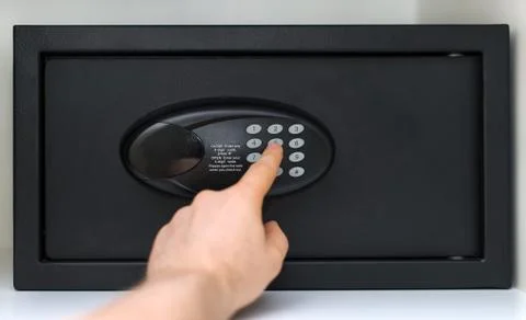 Man's hand opening small safe. Stock Photos