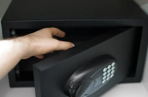 Man's hand opening small safe. Stock Photos