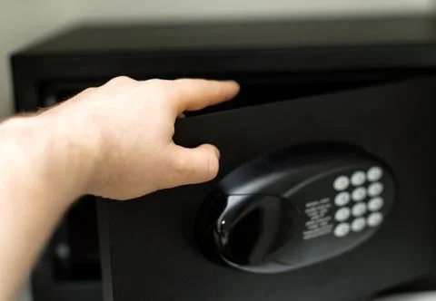 Man's hand opening small safe. Stock Photos