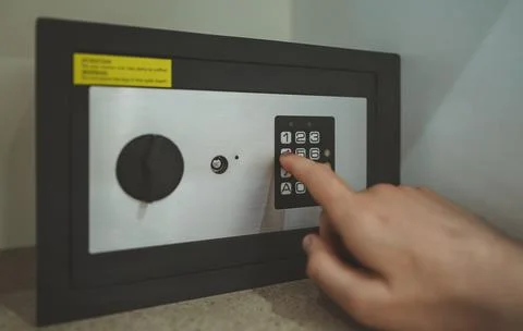 Man's hand opening small safe. Stock Photos