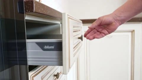 A man's hand opens and closes the kitchen drawer with BLUM fittings. Stock Footage 196727642
