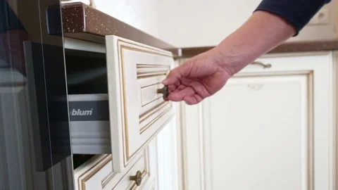 A man's hand opens and closes the kitchen drawer with BLUM fittings. Stock Footage 196821643