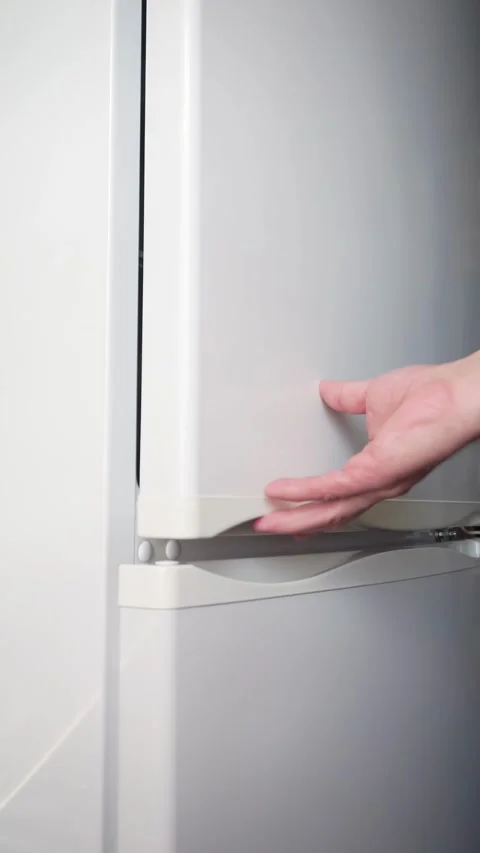 A man's hand opens and closes the refrigerator doors Stock Footage 281940194