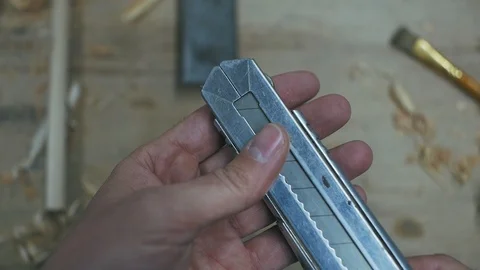 Man's hand opens the blade of a carpenter's knife Stock Footage 102443069