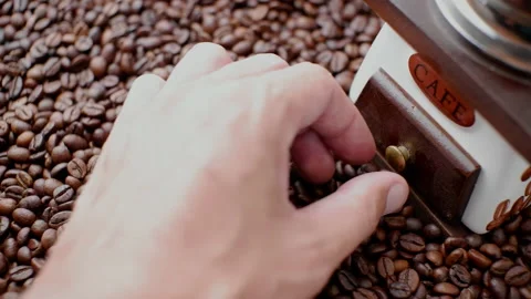 A man's hand opens the cofee grinder tray with freshly ground coffee. A scatt Stock Footage 156210004