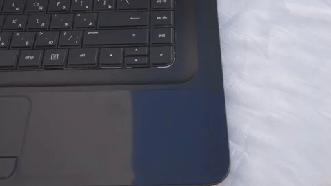 A man's hand opens the computer's drive and inserts the disk. Stock Footage 132966969