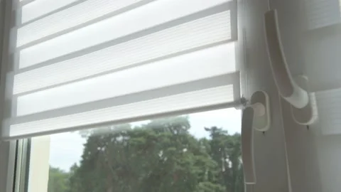 A man's hand opens the day-night blinds on a window. Stock Footage 183265008