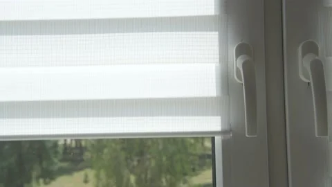 A man's hand opens the day-night blinds on a window. Stock Footage 183265016
