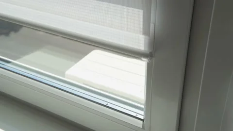 A man's hand opens the day-night blinds on a window. Video stock 183265018