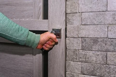 A man's hand opens the door. close-up Stock Photos