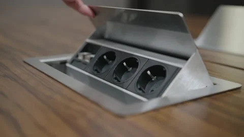 A man's hand opens a drawer with electrical outlets built into the table Stock Footage 221231876
