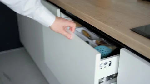 Man's hand opens a drawer in the kitchen with kitchen utensils Stock Footage 153289617