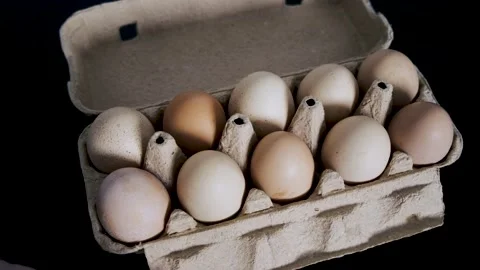 A man's hand opens an egg tray and takes one. Close-up Stock Footage 233275232