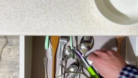 A man's hand opens a kitchen table drawer and takes out cutlery. Top view. Stock Footage 328069547