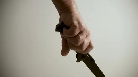 A man's hand opens a knife and plays with it Stock Footage 100878574