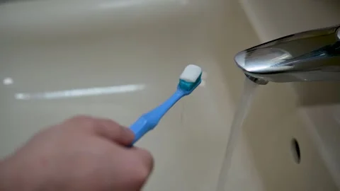 A man's hand opens the tap of the faucet with one hand Stock Footage 257371787