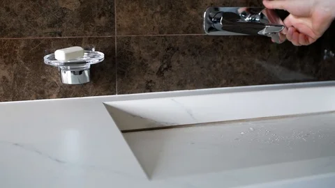 The man's hand opens the tap with water at bathroom.  Сloseup Stock Footage 124374404