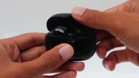 Man's hand opens wireless earphone or headset bluetooth Stock Footage 284888446