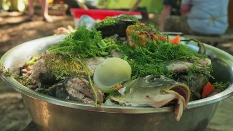 Man's hand parcels the boiled fish up to eat it. Tourist's lunch Stock Footage 138254158