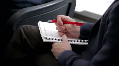 Man's hand with pen lying on exercise book Stock Footage 60616454