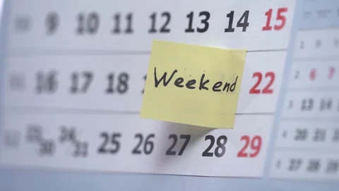 Man's hand pick up the Calendar Mark weekend Stock Footage 153913374