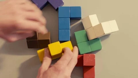 Man's hand picking 3D tetris Stockbeeldmateriaal 73820294