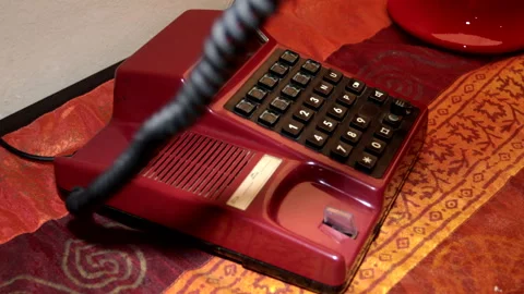 A man's hand picking up the handset of an 80s and 90s telephone. Stock Footage 241341982