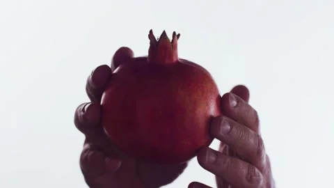 A man's hand is picking up a pomegranate. Low angel shot Video stock 199028888