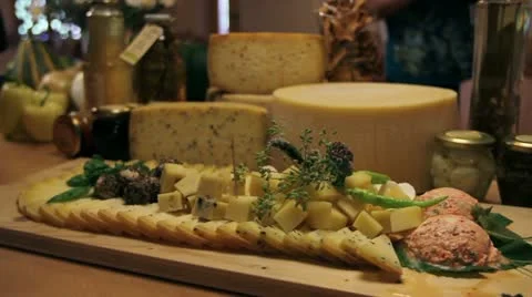 Man's hand picking served cheese from board Vidéo 27863019