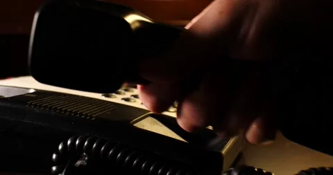 Man's hand picking up telephone to make important phone call slider Dolly shot Video stock 213389339