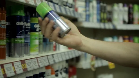 Man's hand picks deodorant on the store shelf Stock Footage 102274929