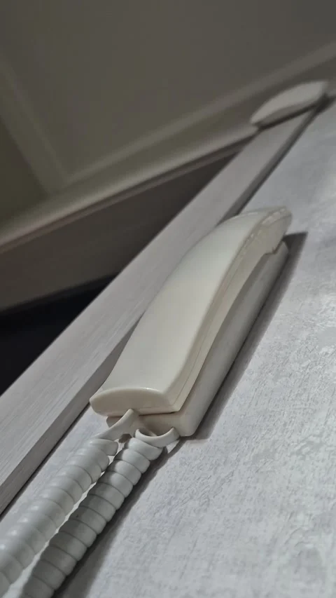 A man's hand picks up the intercom receiver at the entrance to an apartment Stock Footage 302574951