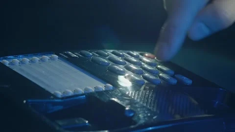Man's hand picks up the receiver of a black shiny push-button old telephone Stock Footage 287958481