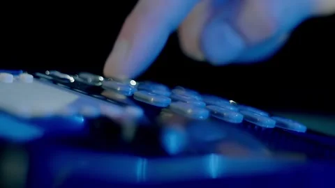 Man's hand picks up the receiver of a black shiny push-button old telephone Vídeos de archivo 297799014