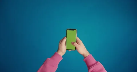 A man's hand in a pink sleeve scrolls the tape on the smartphone screen Stock Footage 149742728
