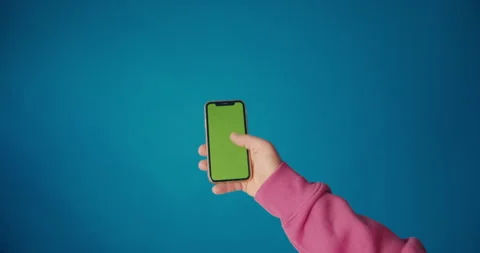 A man's hand in a pink sleeve scrolls the tape on the smartphone screen Stock Footage 149743598