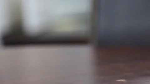 A man's hand places an empty beer glass on a table. The last few drops of Stock Footage 120843819