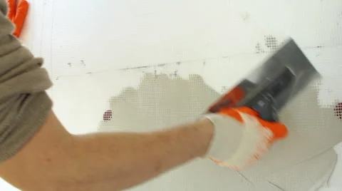 Man's hand plastering a wall with trowel, construction worker repair a home wall Stock-Footage 48698844