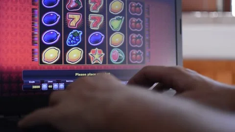 Man's hand play with slot machine and try to win a jackpot. slot addiction. Stock-Footage 211345014