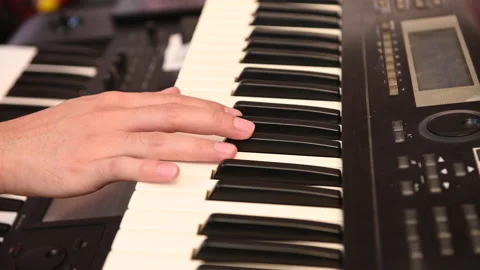 A man's hand playing electone or keyboard Stock Footage 171854897