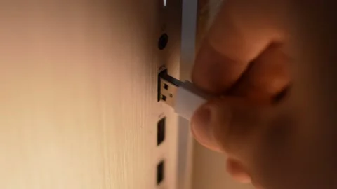 Man's hand plug white usb cable to a data center hard disk computer Stock Footage 197950445