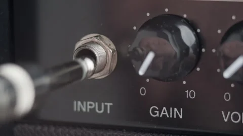 A man's hand plugging electric guitar cable to the amplifier. Close up 스톡 동영상 242068339
