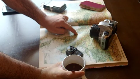A man's hand pointing a route on a map. Concept: travel and adventure Stock Footage 127686553