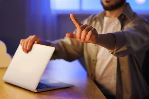 Mans hand pointing at virtual screen with laptop, digital interface interacti Stock Photos