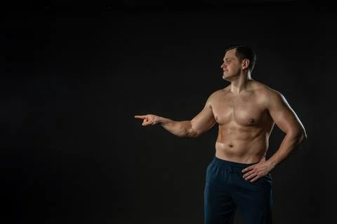 Man's hand points bare torso Young male male fashion, torso casual background Foto stock