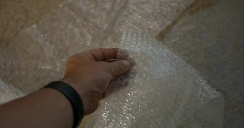 Mans Hand popping Bubble Wrap Stock Footage 76367542