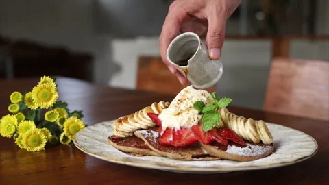 Mans hand pouring maple sirup to Gluten Free Pancakes Stock Footage 162707742