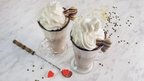 Man's hand pouring red syrup into cocoa drink, close-up. Sweet cocktail with Stock Footage 71691689
